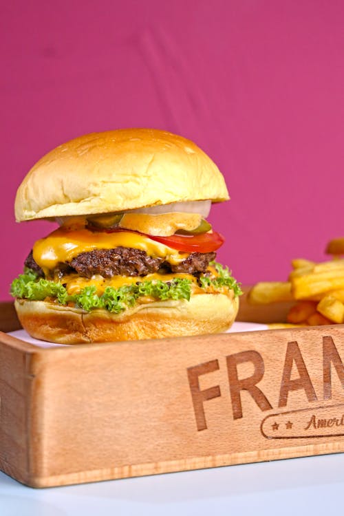 Free A burger and fries on a wooden tray with the word frankie Stock Photo