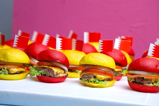 Vibrant red and yellow burgers with Bahrain flags, perfect for festive gatherings or culinary themes.