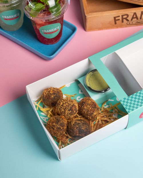 Free Delicious fried snacks served with refreshing drinks in a stylish presentation, perfect for food lovers. Stock Photo