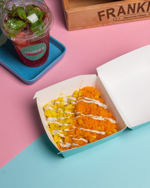 Free Delicious crispy chicken tenders served with a creamy dipping sauce in a modern takeaway setting. Stock Photo