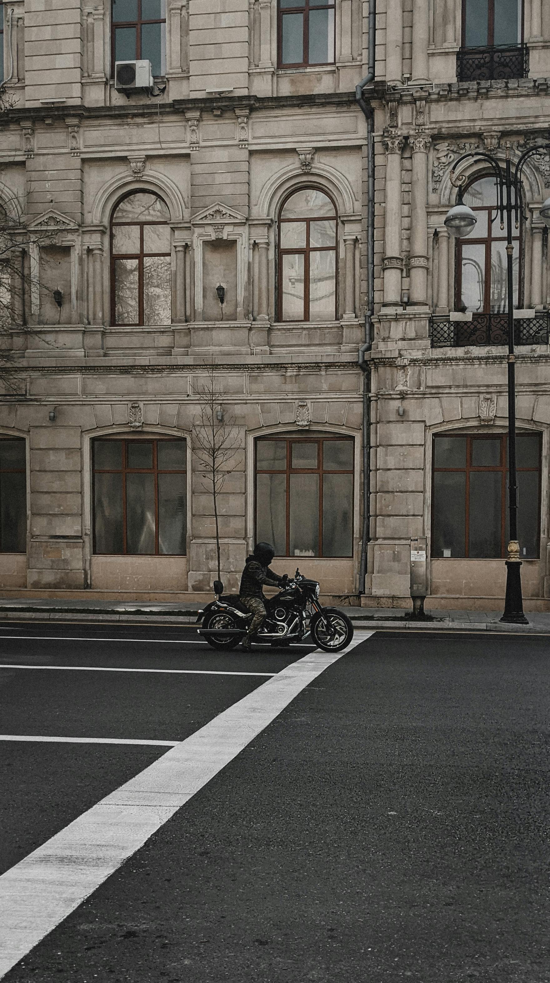 A motorcyclist rides through the historic architectural streets of Baku, Azerbaijan.