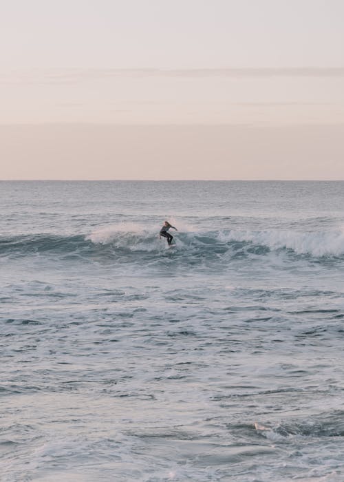 Man Surfing on Board in Ocean