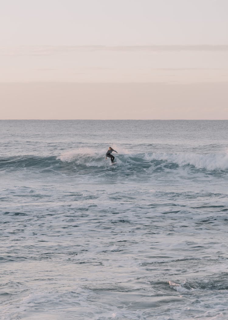 Man Surfing On Board In Ocean