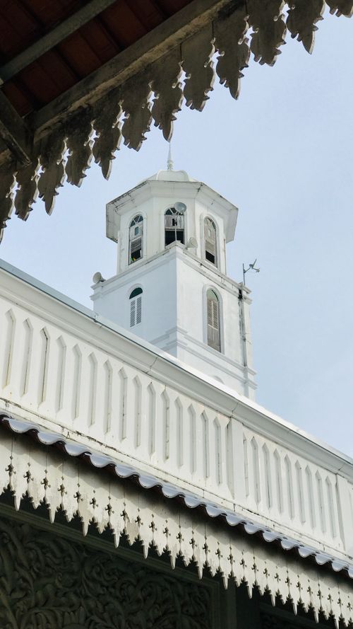 Free Detailed view of a historic white clock tower with intricate decorative patterns. Stock Photo