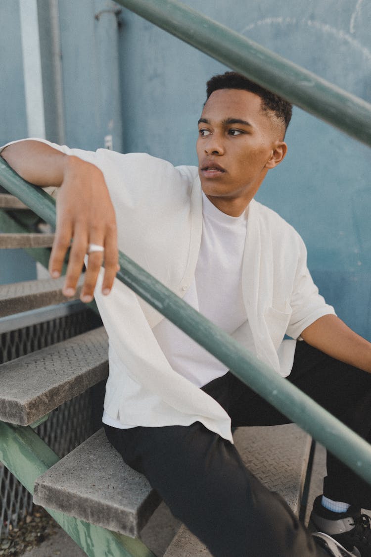 Young Man Sitting On Steps