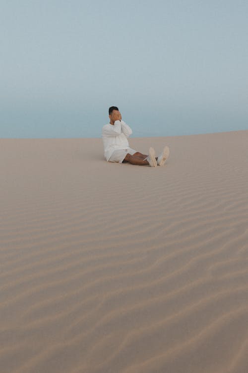 Man Sitting on Sand