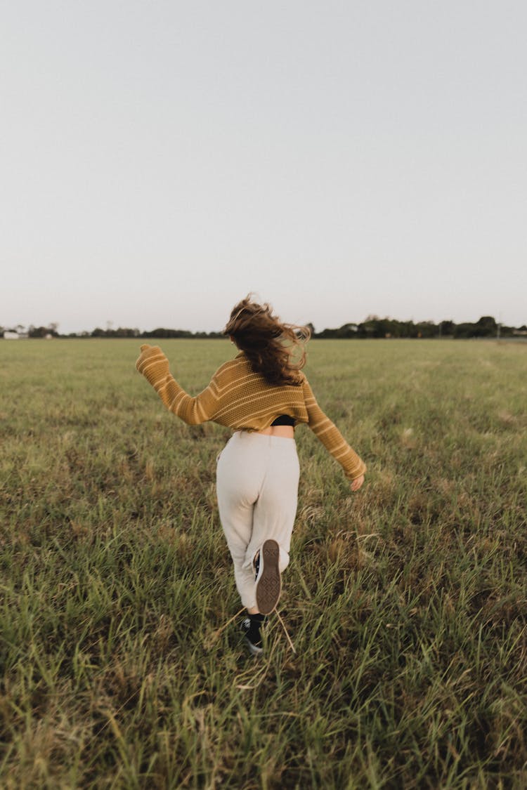 Woman Running In Field