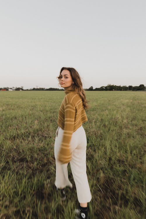 Model in Knitted Sweater and White Pants