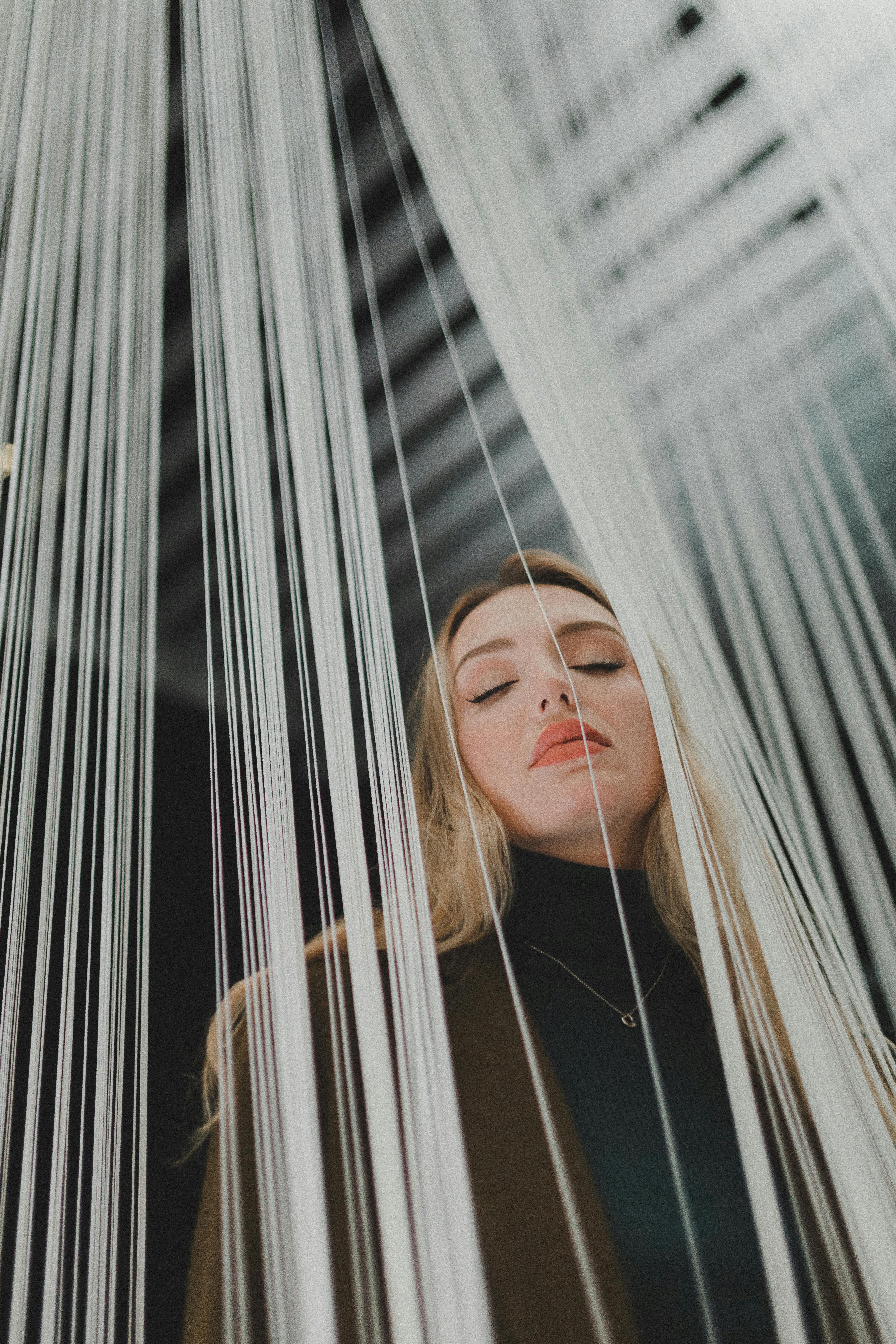 Woman amidst White Strings · Free Stock Photo
