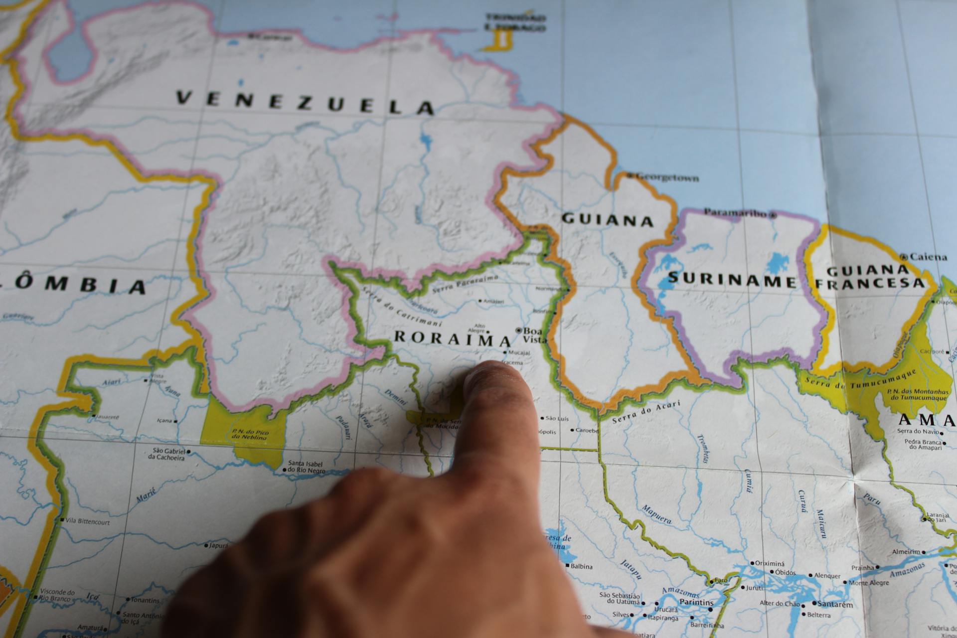 Person Pointing at Brazilian State of Roraima on a Map