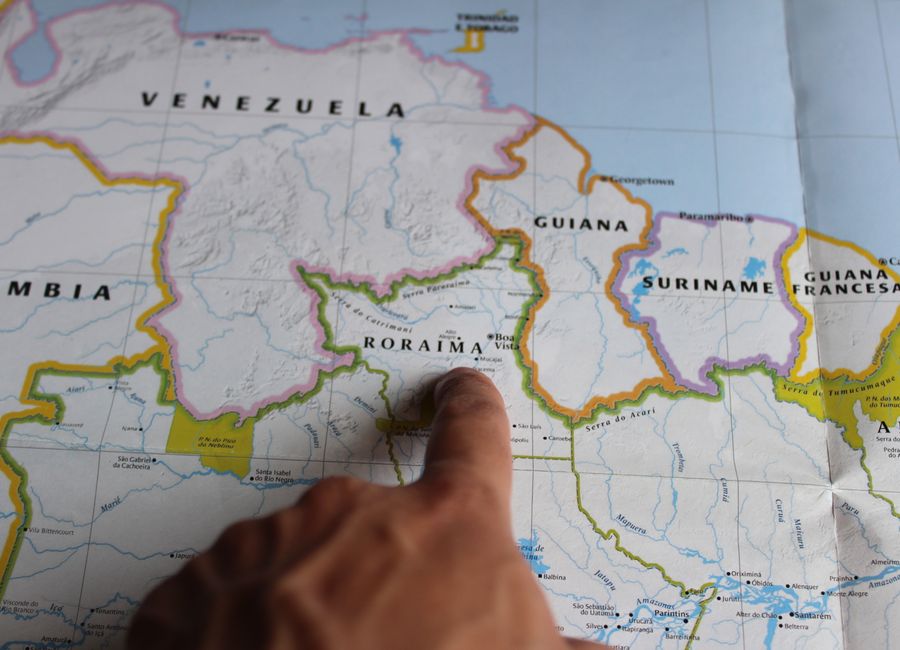 Discover Roraima, Brazil with a finger pointing on a detailed map.