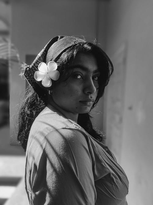 Woman with Flower in Hair Posing Outdoors