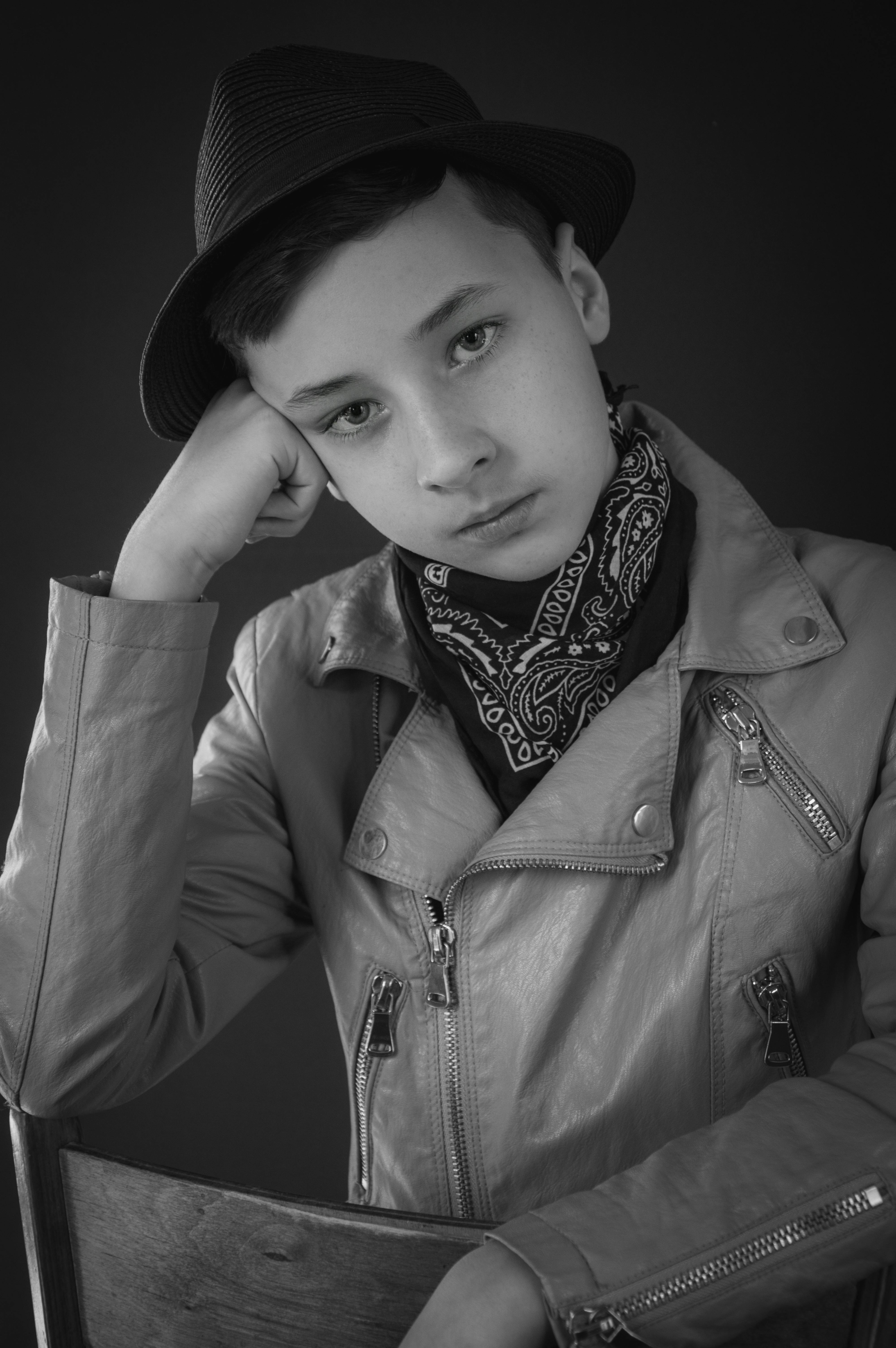 grayscale photo of boy wearing leather jacket