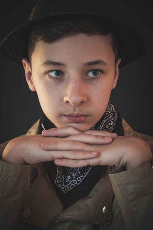 Close Up Photo of a Boy with His Hands Together