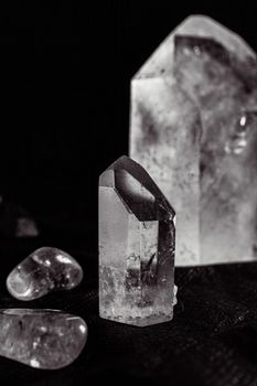 A vertical shot highlighting clear quartz crystals on a dark background, emphasizing their luxury and allure.