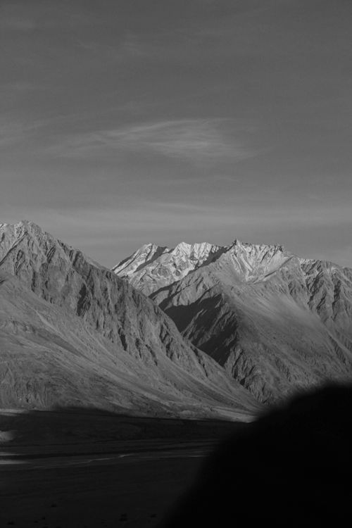Free Stunning black and white view of a mountain range under clear skies. Stock Photo