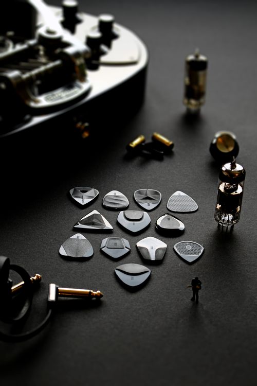 Free Artistic display of guitar picks and components on a dark surface, showcasing musical details. Stock Photo