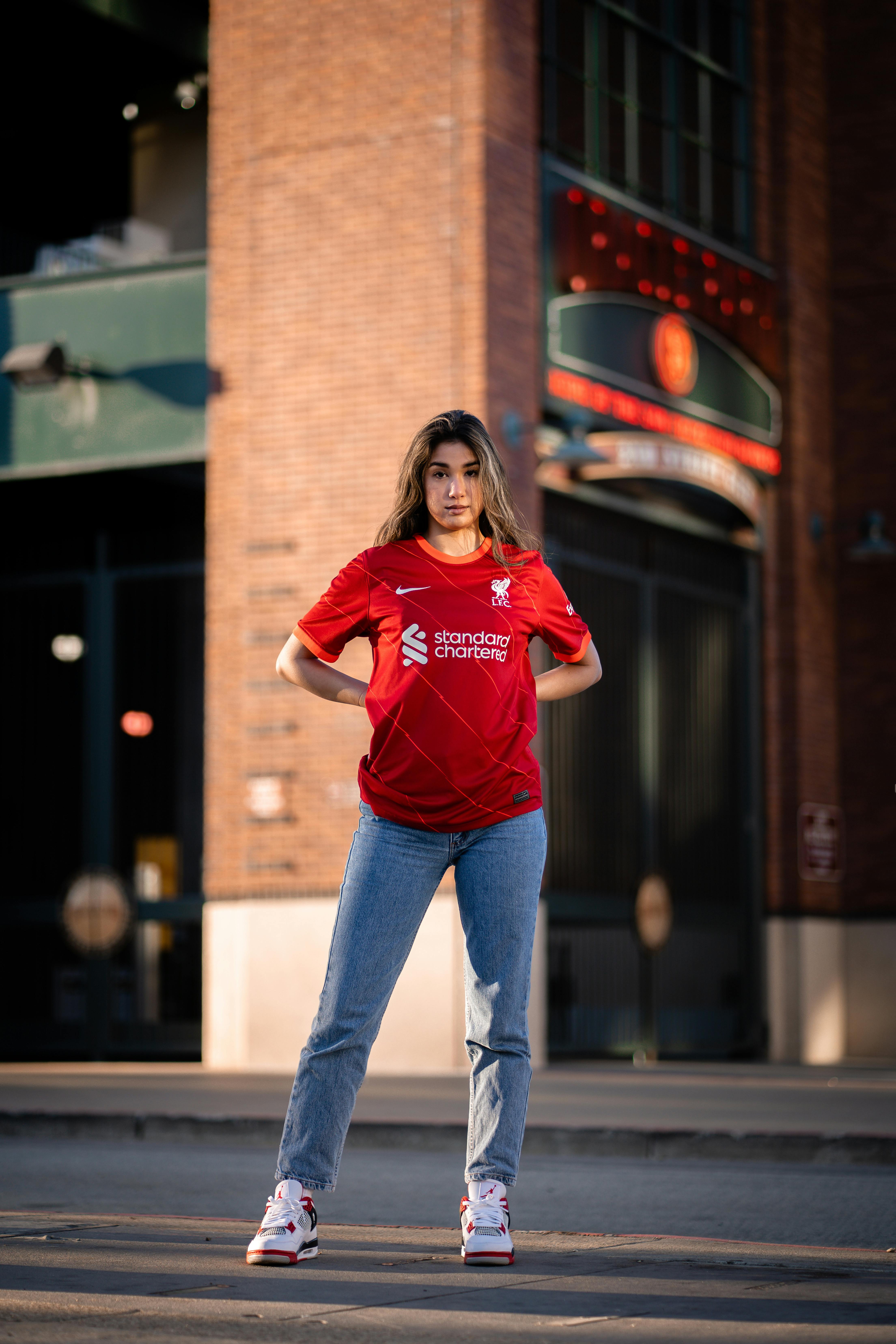 Young Woman in a Football Liverpool FC T-shirt · Free Stock Photo