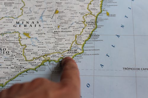 Hand Pointing Rio de Janeiro on Map