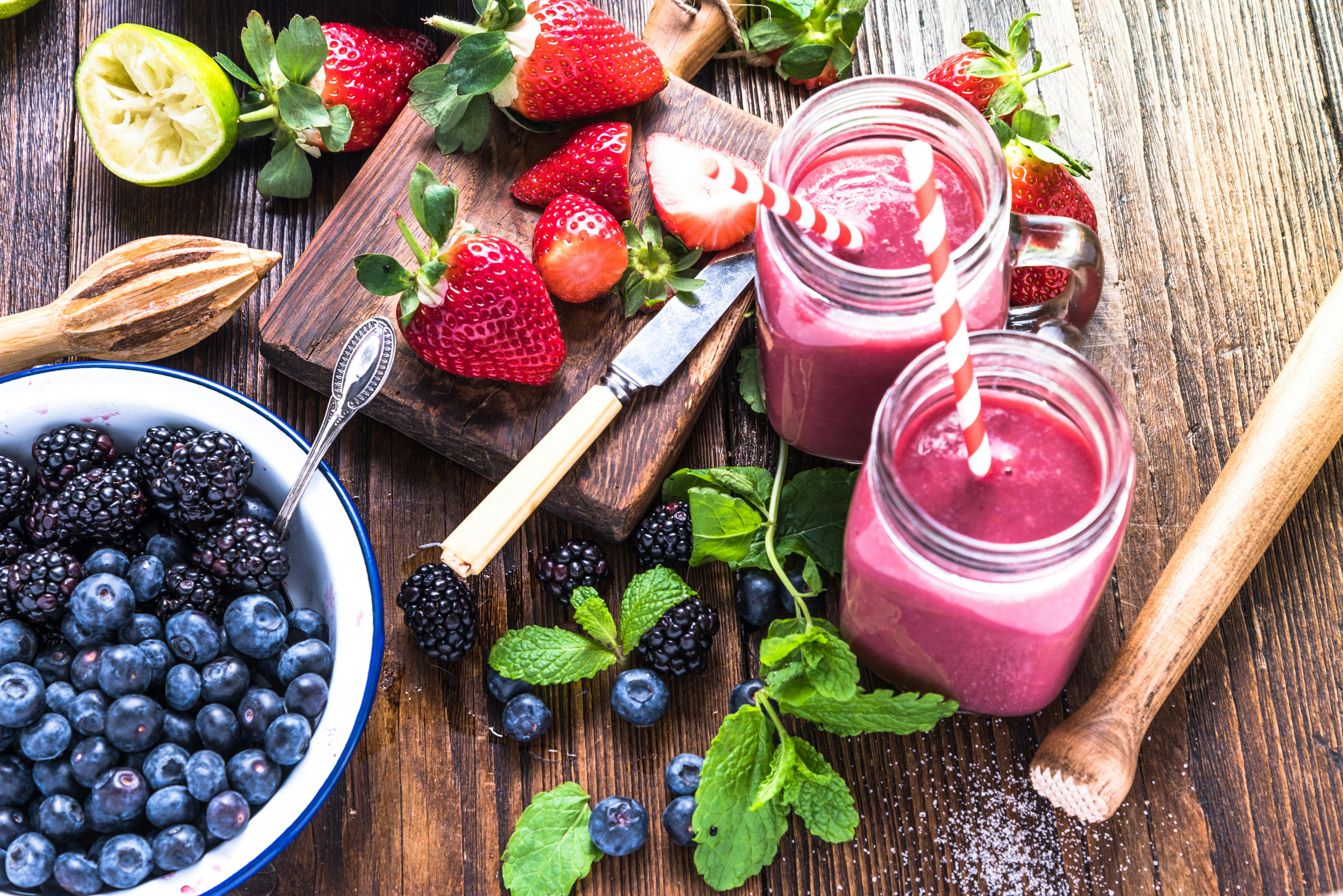 Blueberries, Strawberries And Raspberries On Brown Wooden Surface