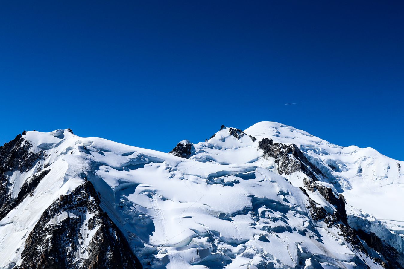 Snow-covered mountains under a clear sky representing high altitude baking conditions