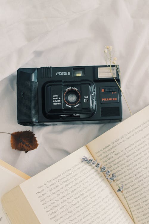 Vintage Camera next to a Book 