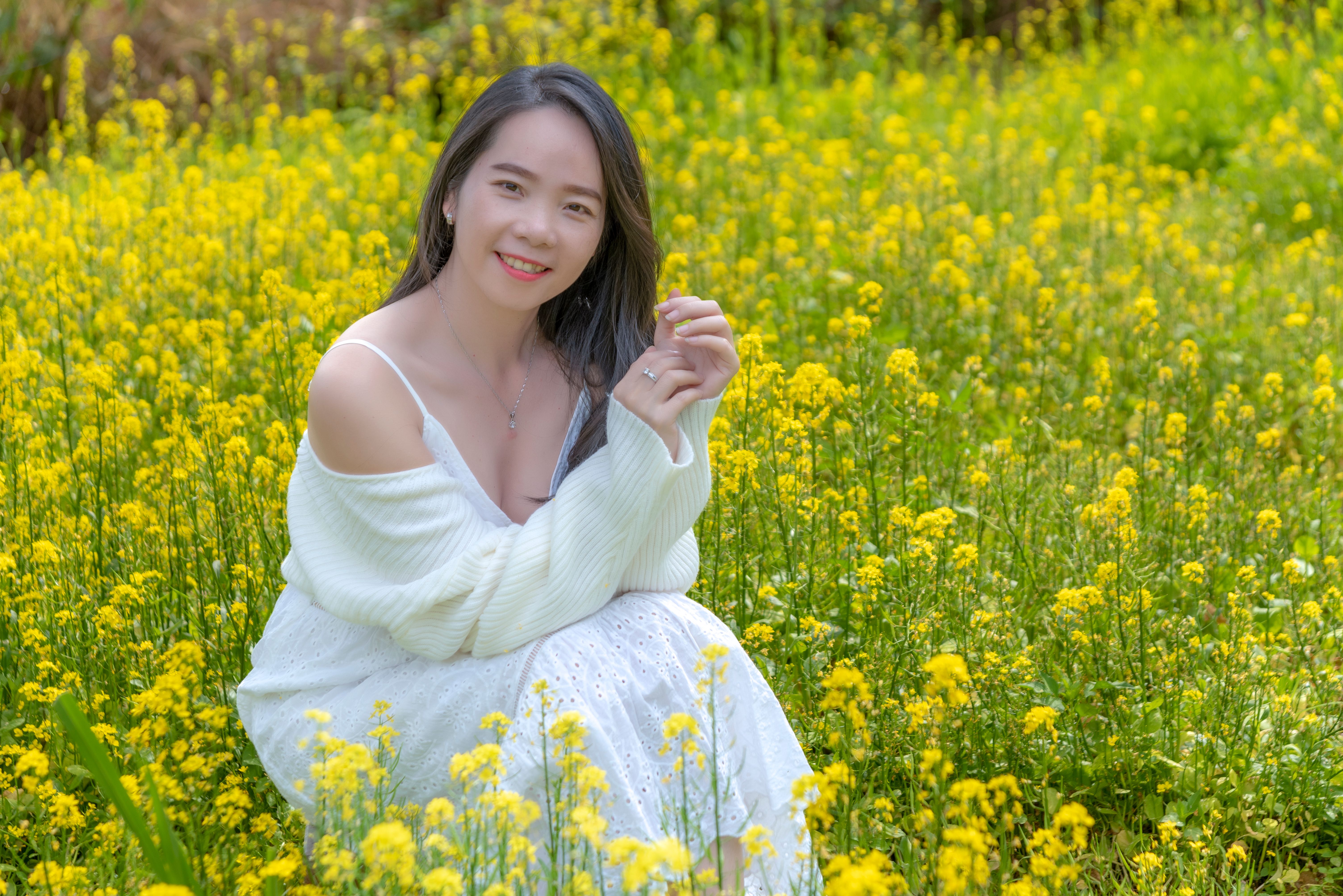 Woman in White Dress Sitting on Meadow with Flowers · Free Stock Photo