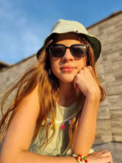 A Woman Wearing Sunglasses and Bucket Hat 