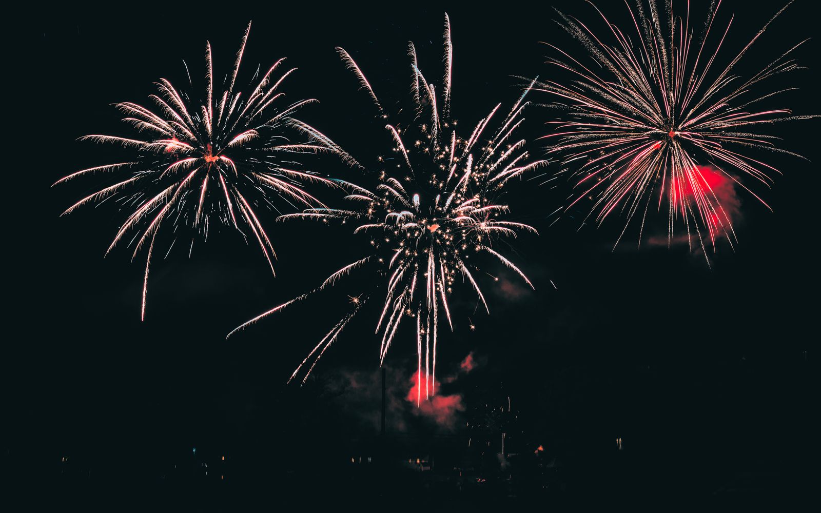 Fireworks bursting in color over a dark night sky