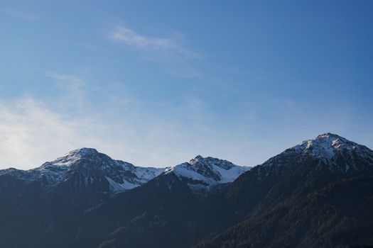 A stunning view of snow-capped mountains under a clear blue sky, perfect for travel and nature enthusiasts.