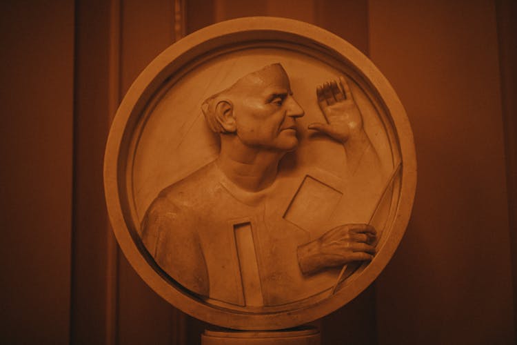 Sculpture Of Man On Circular Plate