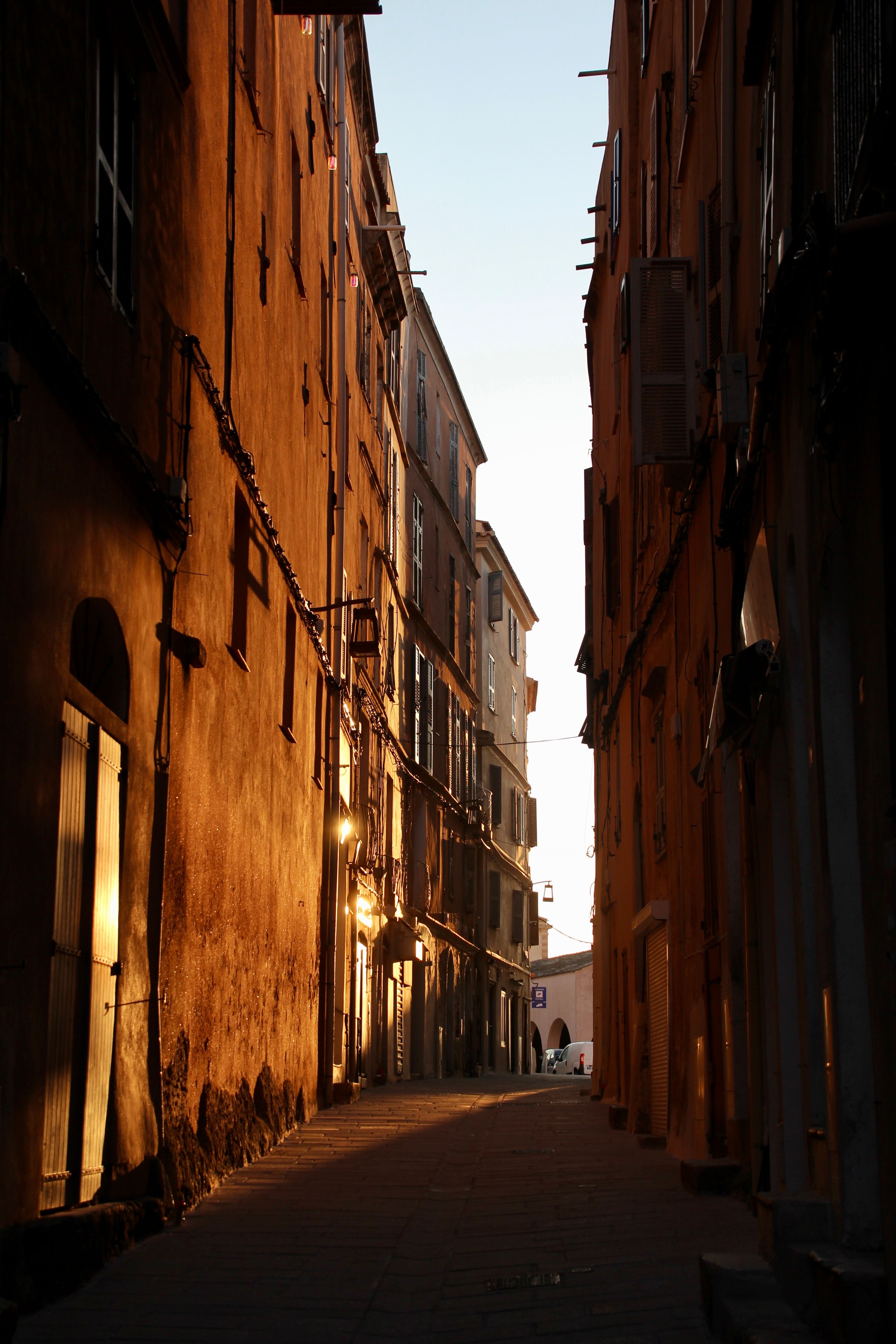 Beautiful narrow alleyway illuminated by the soft glow of dusk, with historic buildings lining the path.