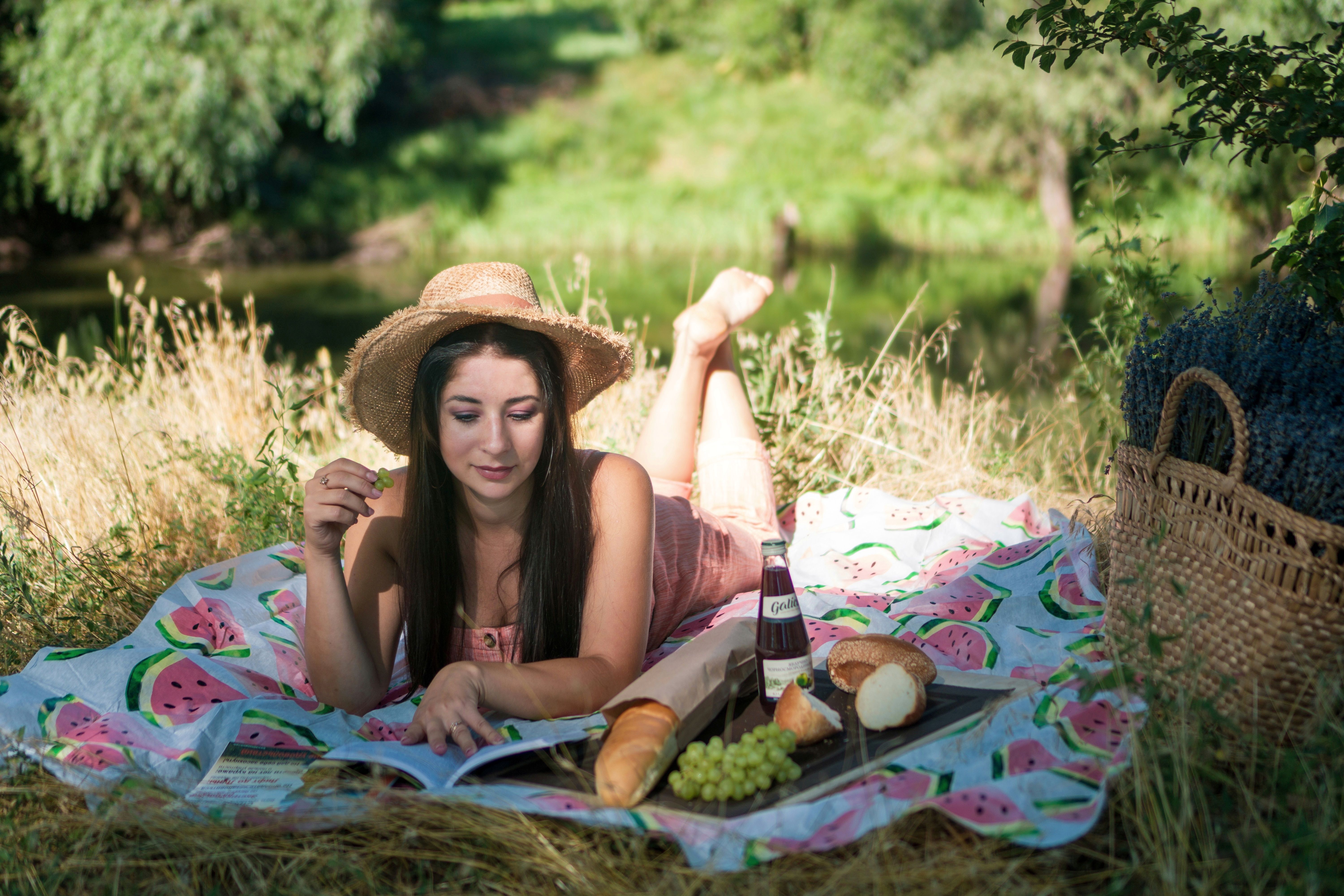 Woman Lying on a Picnic Blanket · Free Stock Photo