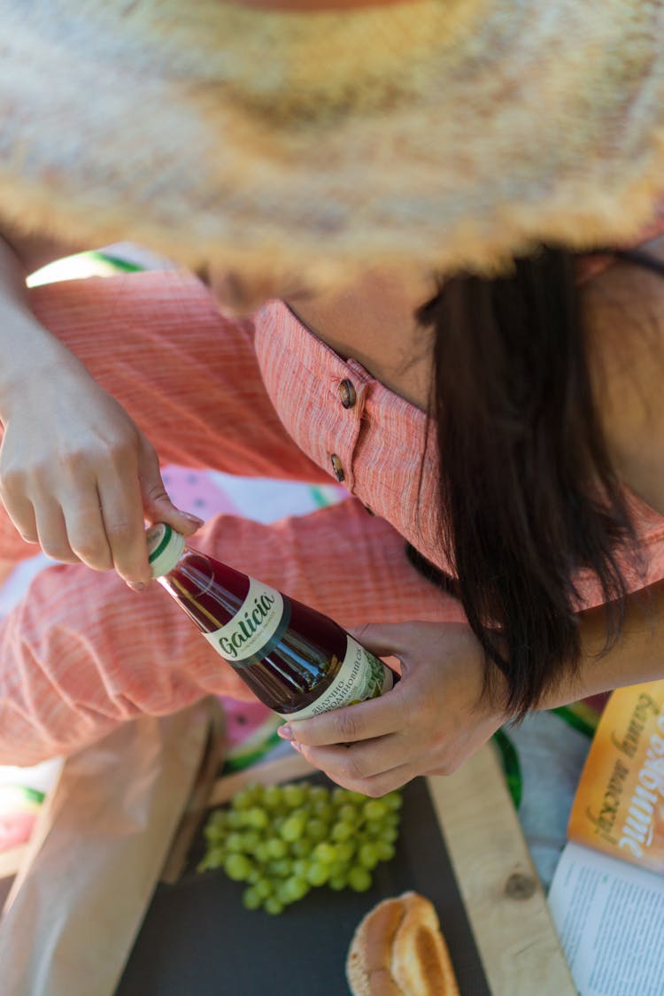 Close Up Of Woman Opening Beer Bottle