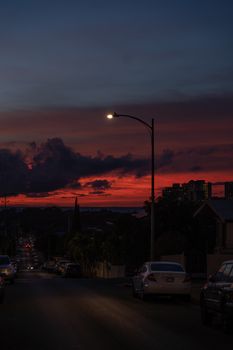 Street view of a city at dusk with a dramatic sky and urban landscape.