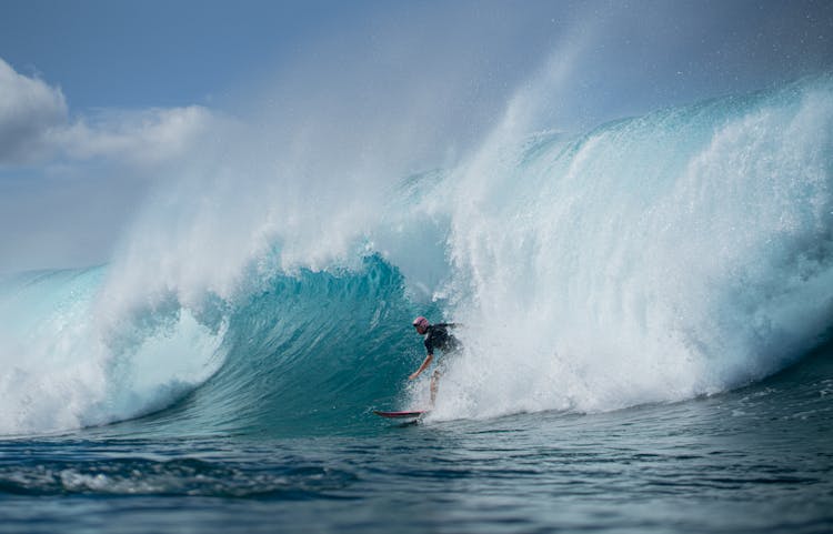 Man Surfing On Board On Wave In Ocean