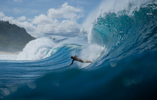 Man Surfing on Wave in Ocean
