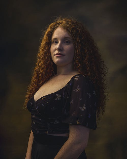 A Woman in Black Blouse with Curly Hair 