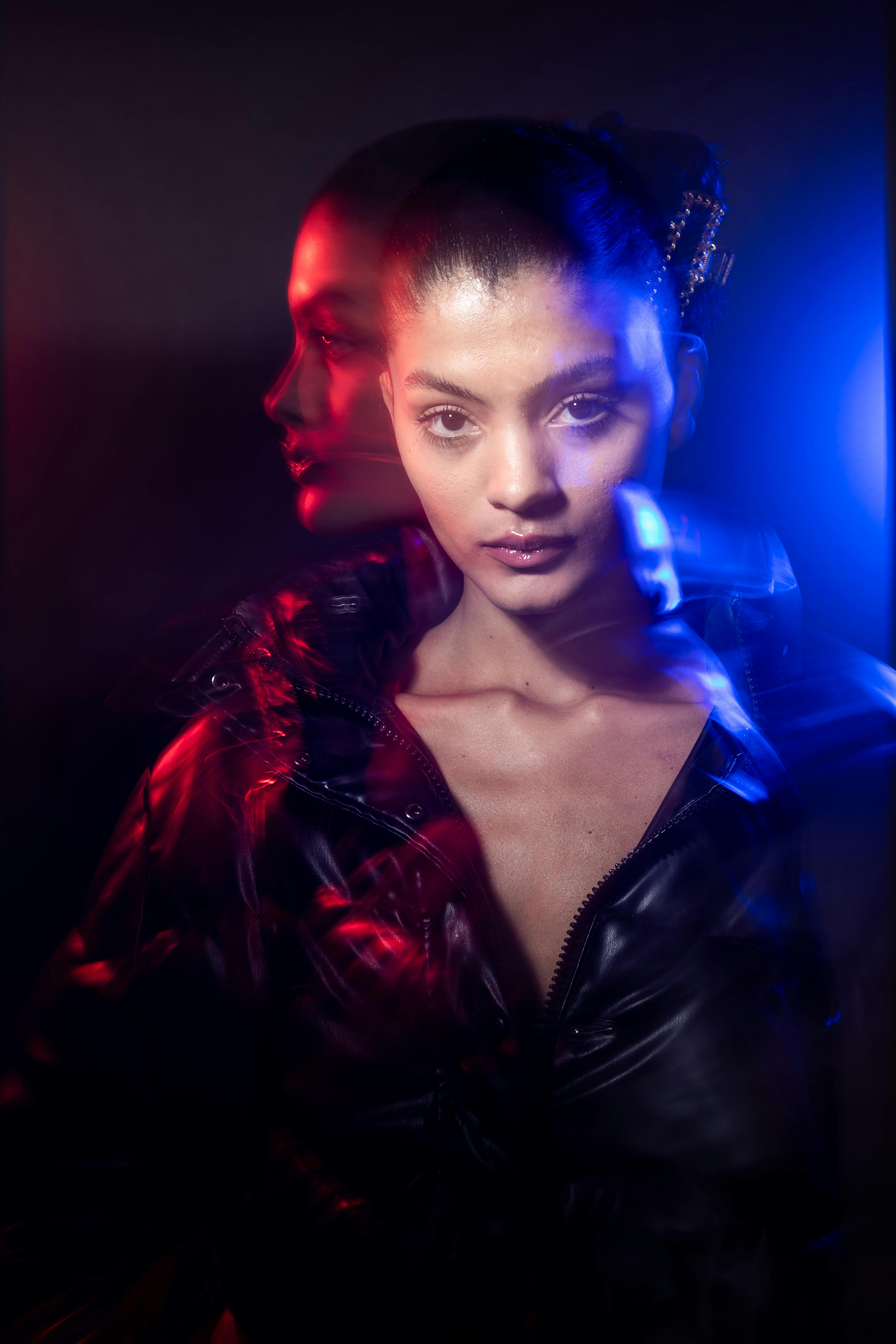 Artistic portrait featuring a woman with creative light effects on a dark background.