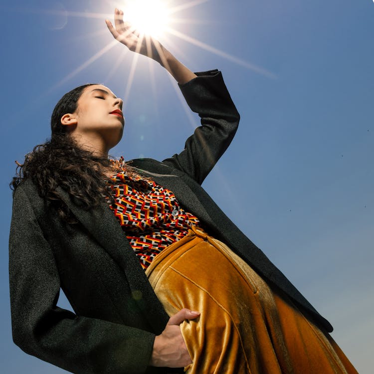 Woman Posing With Hand Over Sun