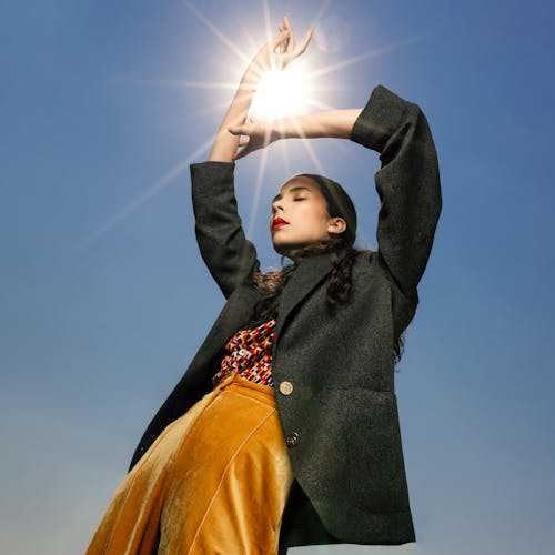 Woman Posing with Sun between Hands