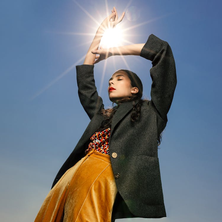 Woman Posing With Sun Between Hands