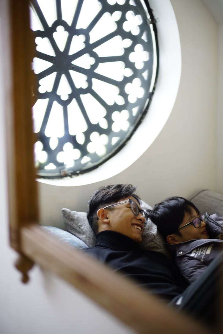 Smiling Man And Child Relaxing At Home