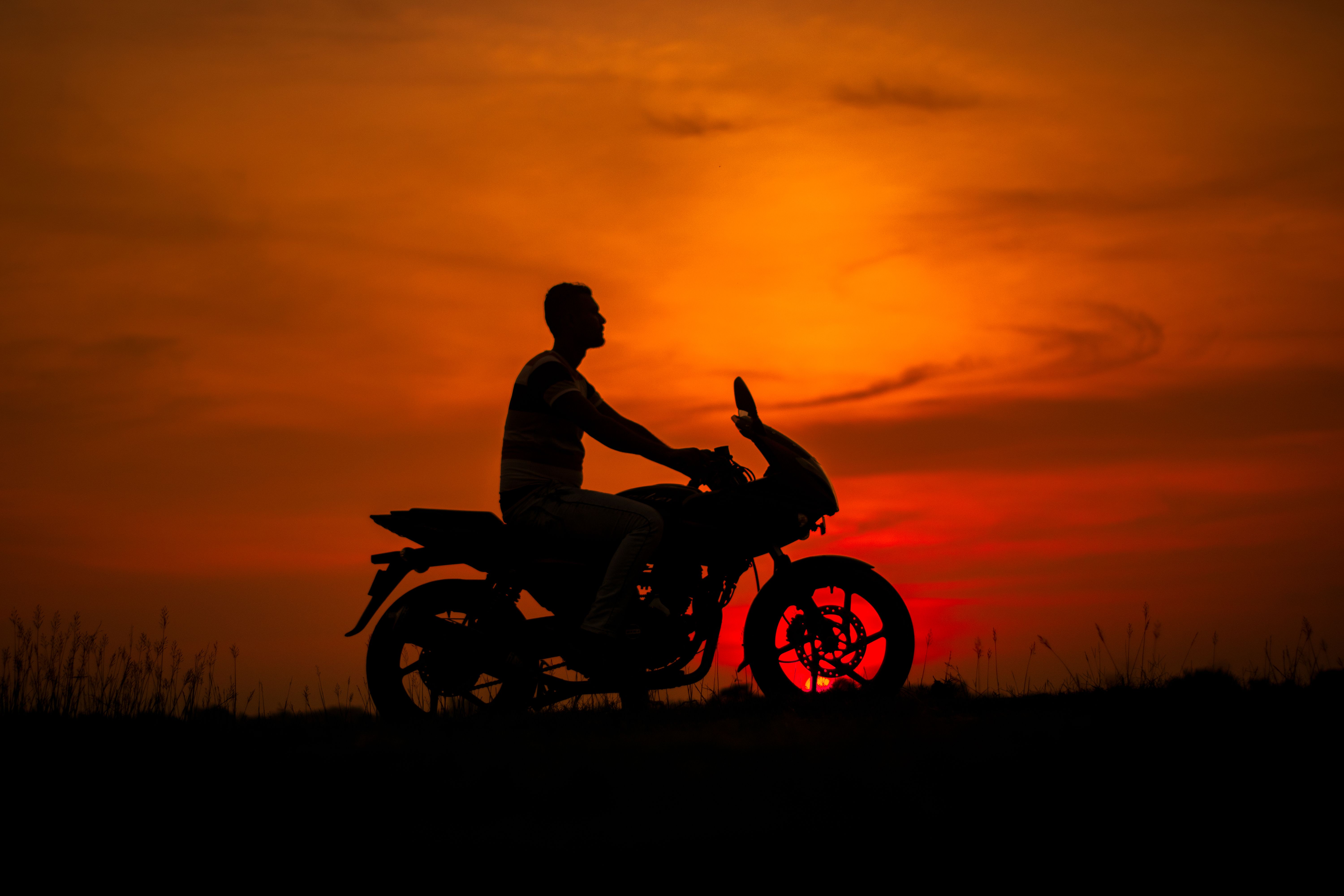 Silhouette of a Man Riding a Motorcycle at Sunset · Free Stock Photo