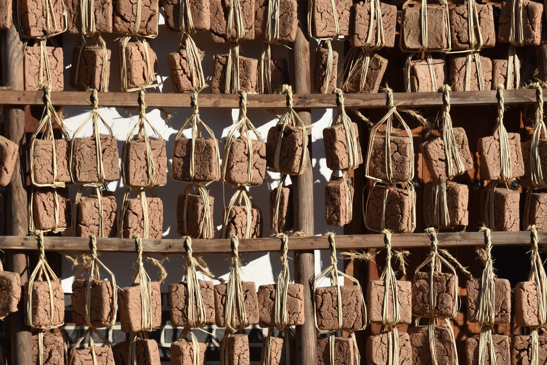 Authentic Korean meju blocks hanging outdoors for fermentation, essential in Korean cuisine.