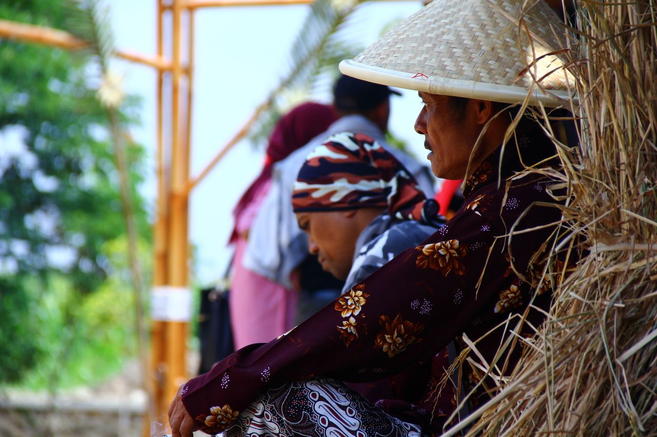 traditional farmers in colorful clothing take a break outdoors highlig