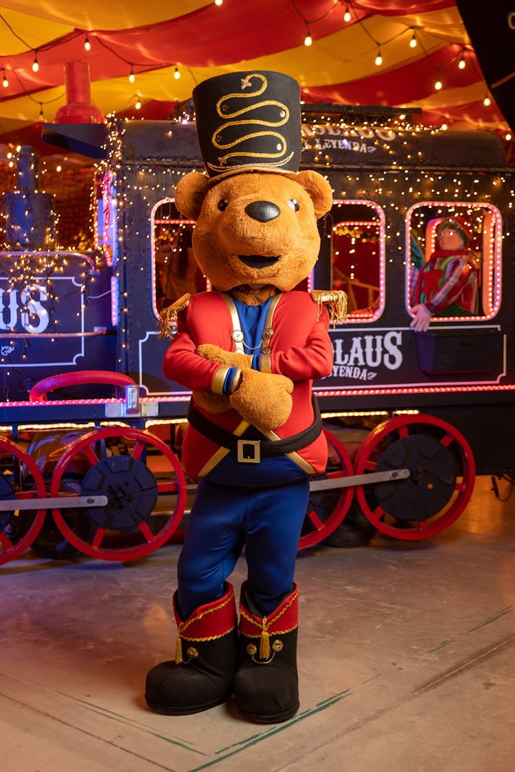 Person In Nutcracker Costume Standing Beside A Carnival Train