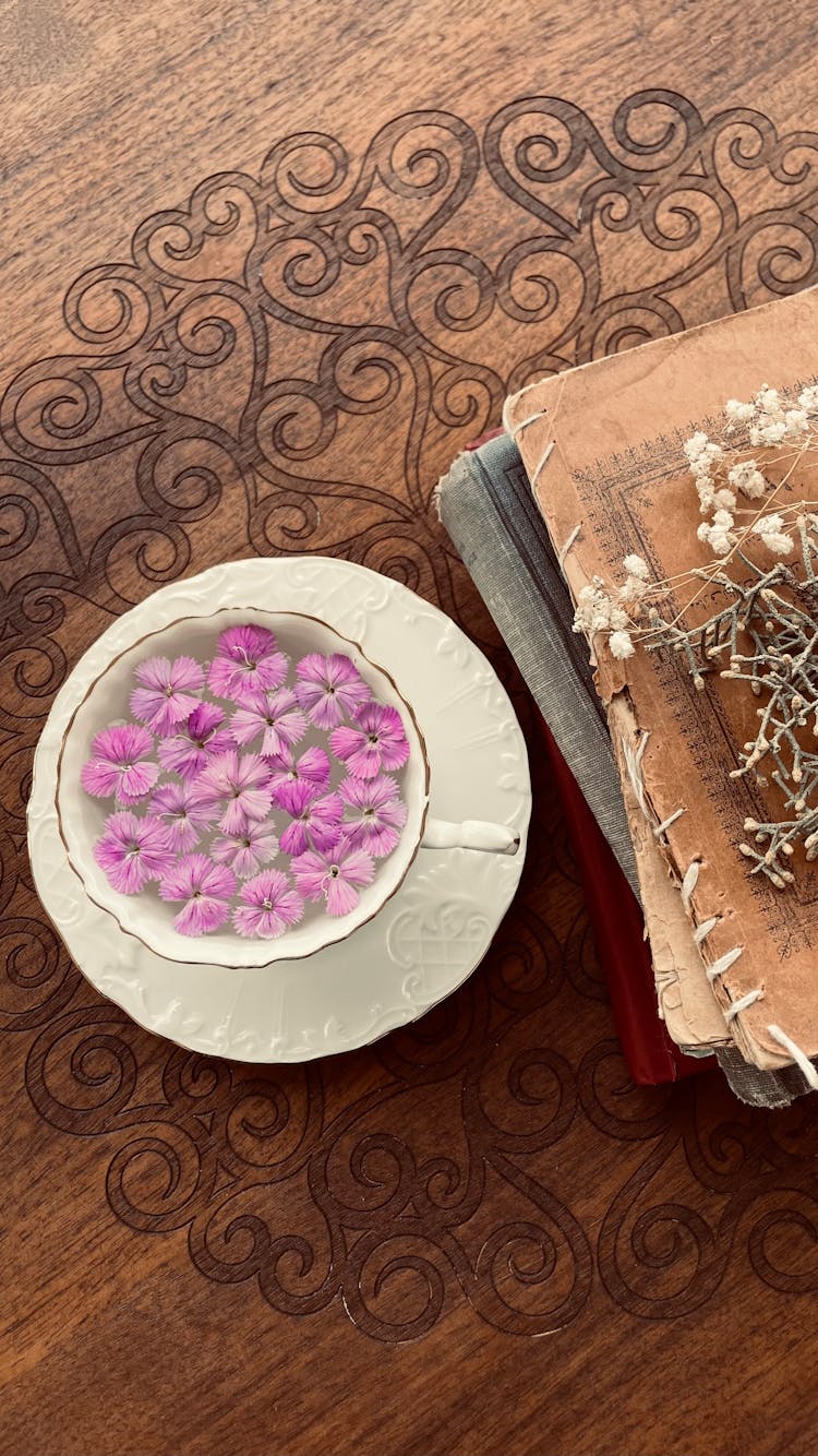 Vintage Book Covers And Petals In Cup