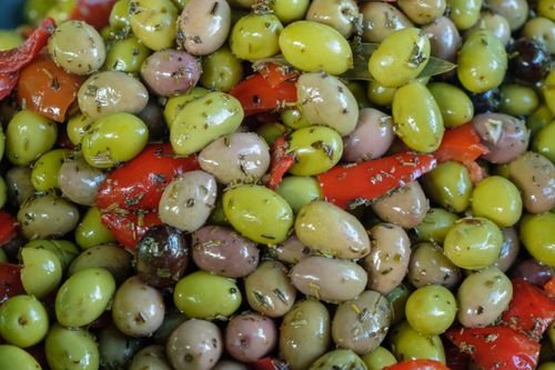 Free Vibrant mix of marinated olives and red peppers. Perfect for food photography. Stock Photo