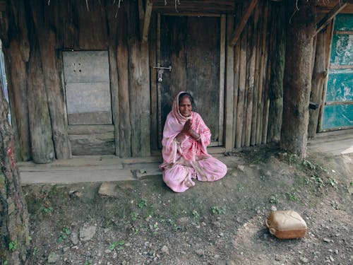 Woman Praying at Doorstep